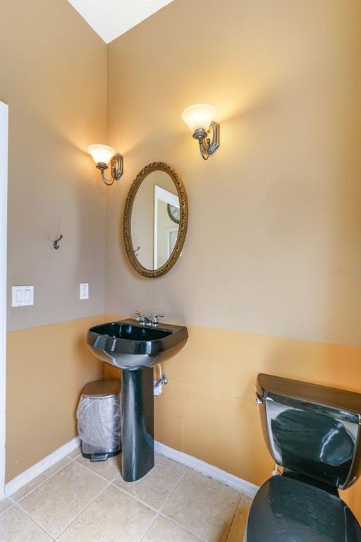 3362 Cedar Crest Loop Spring Hill, FL 34609 - Photo 27 of 57 a bathroom with a sink and a mirror