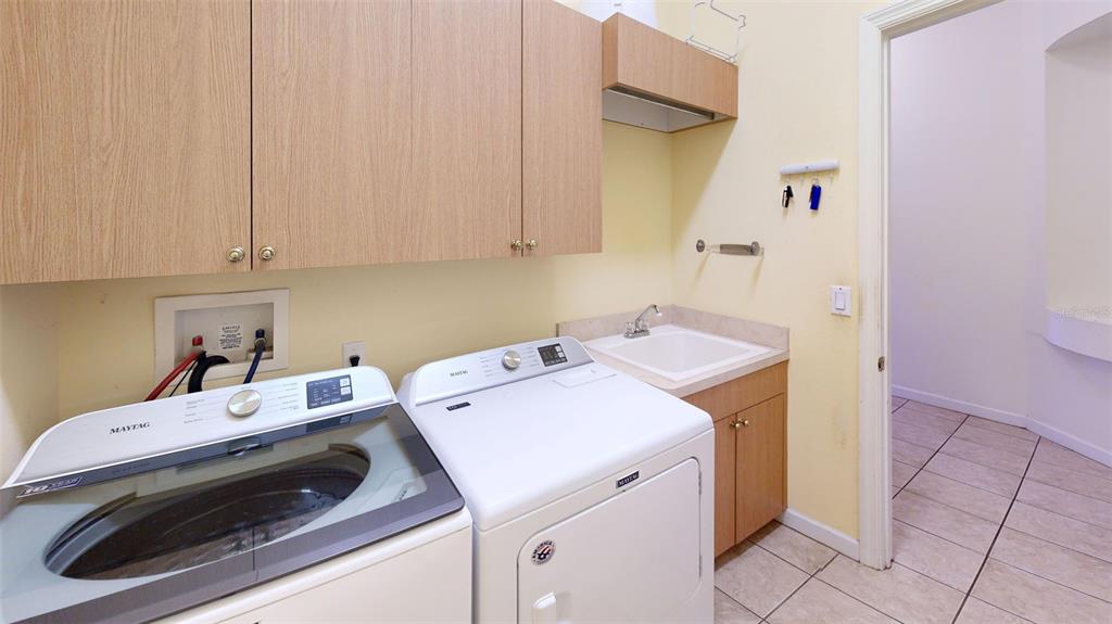 3362 Cedar Crest Loop Spring Hill, FL 34609 - Photo 28 of 57 a utility room with dryer and washer