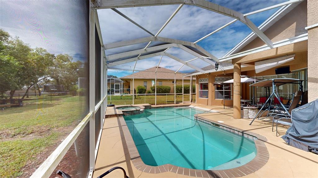 3362 Cedar Crest Loop Spring Hill, FL 34609 - Photo 36 of 57 a view of a swimming pool with a patio