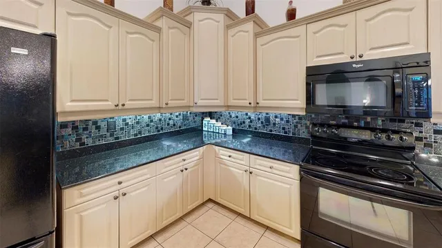 a dining room with furniture a chandelier and wooden floor
