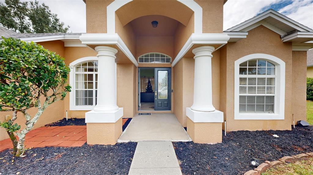 3362 Cedar Crest Loop Spring Hill, FL 34609 - Photo 52 of 57 a front view of a house with a yard