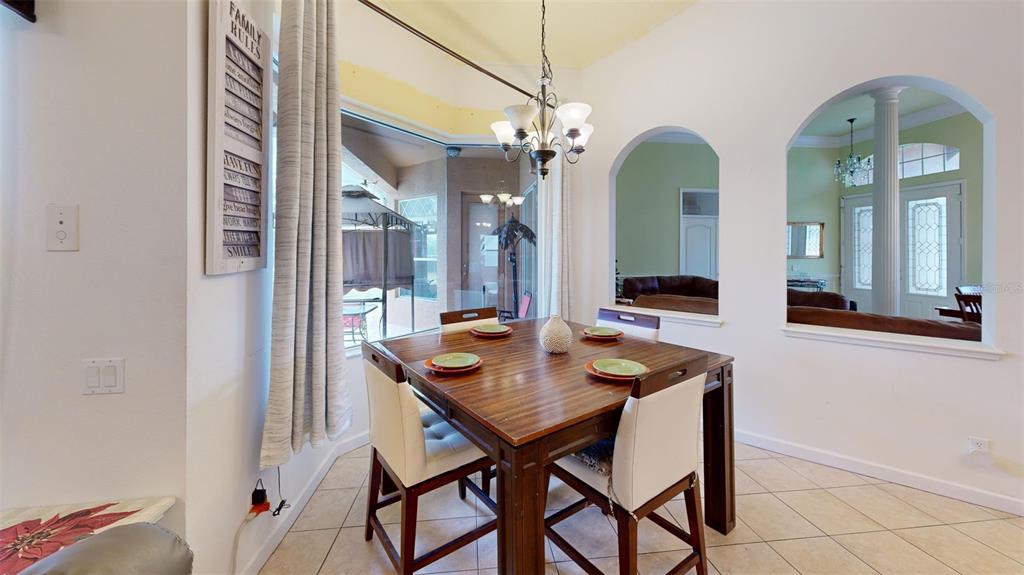3362 Cedar Crest Loop Spring Hill, FL 34609 - Photo 7 of 57 a view of a dining room with furniture and a chandelier