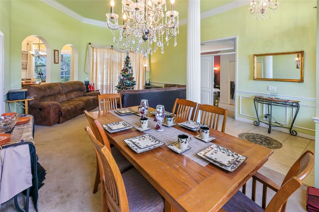 3362 Cedar Crest Loop Spring Hill, FL 34609 - Photo 10 of 57 a living room with furniture a chandelier and a dining table