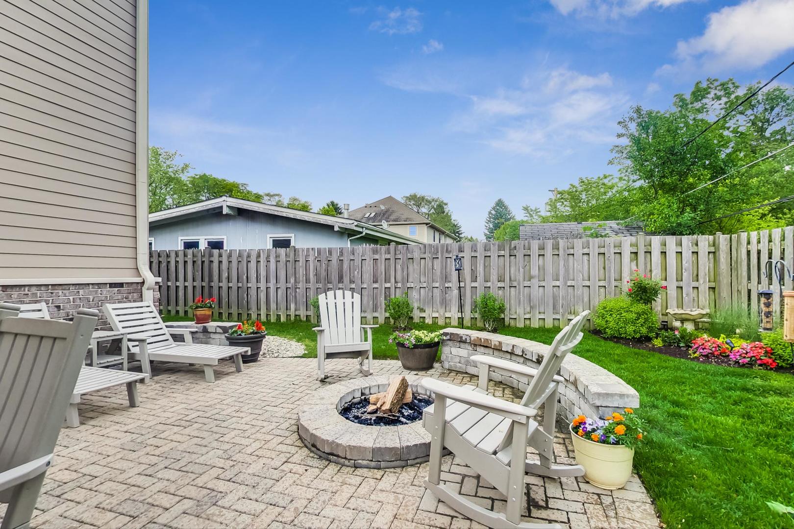 1049 Greentree Avenue Deerfield, IL 60015 - Photo 34 of 37 a view of a patio with a dining table and chairs with wooden fence
