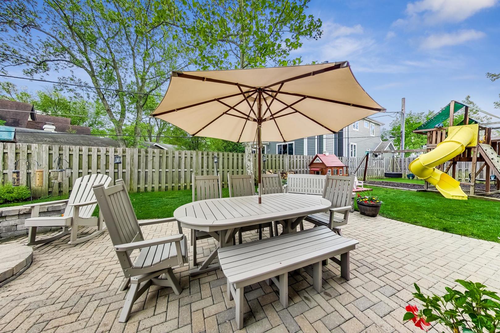 1049 Greentree Avenue Deerfield, IL 60015 - Photo 35 of 37 a view of a patio with a table and chairs under an umbrella