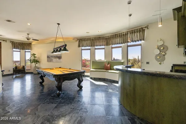 a bathroom with a granite countertop sink a mirror and shower