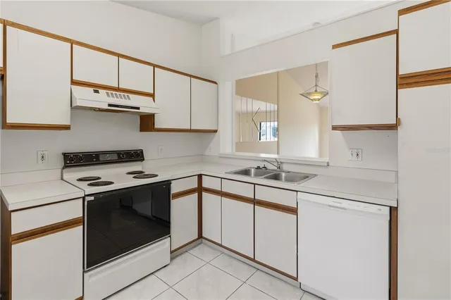 an empty room with a window and mirror