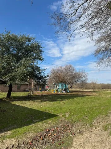 a view of yard with ocean and trees
