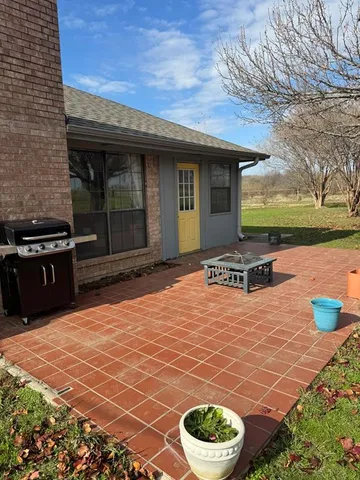 a view of a backyard with a patio