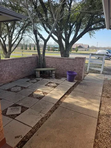 a view of yard with tree in front of it