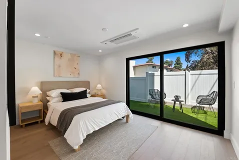 a bedroom with a large bed and a large window