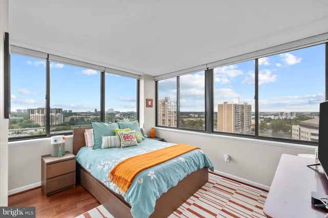 a bedroom with a large bed and a large window