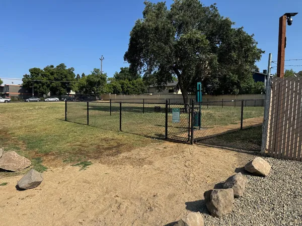 a view of a yard with wooden fence