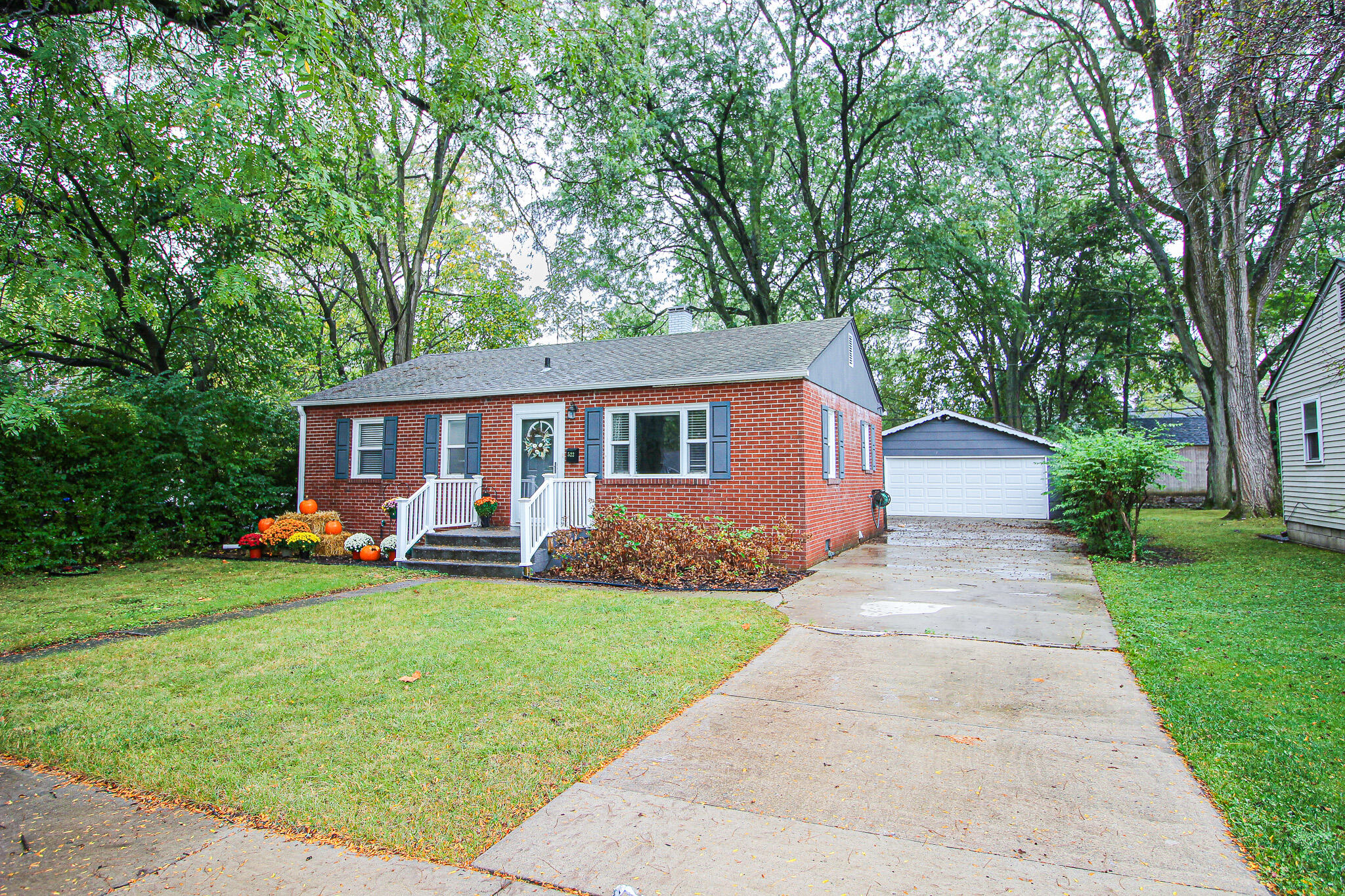 a front view of house with yard and green space