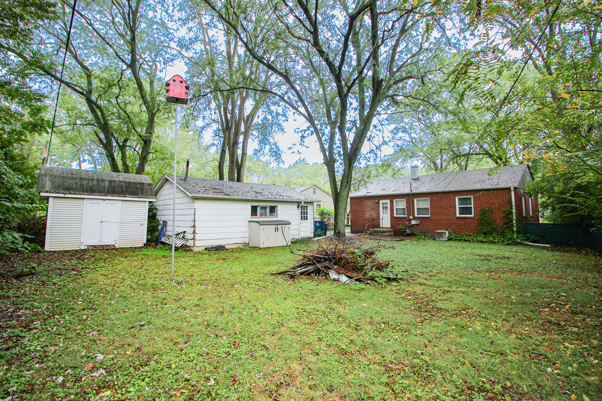 522 Dexter Drive Crown Point, IN 46307 - Photo 18 of 21 a house that is sitting in the grass with large trees