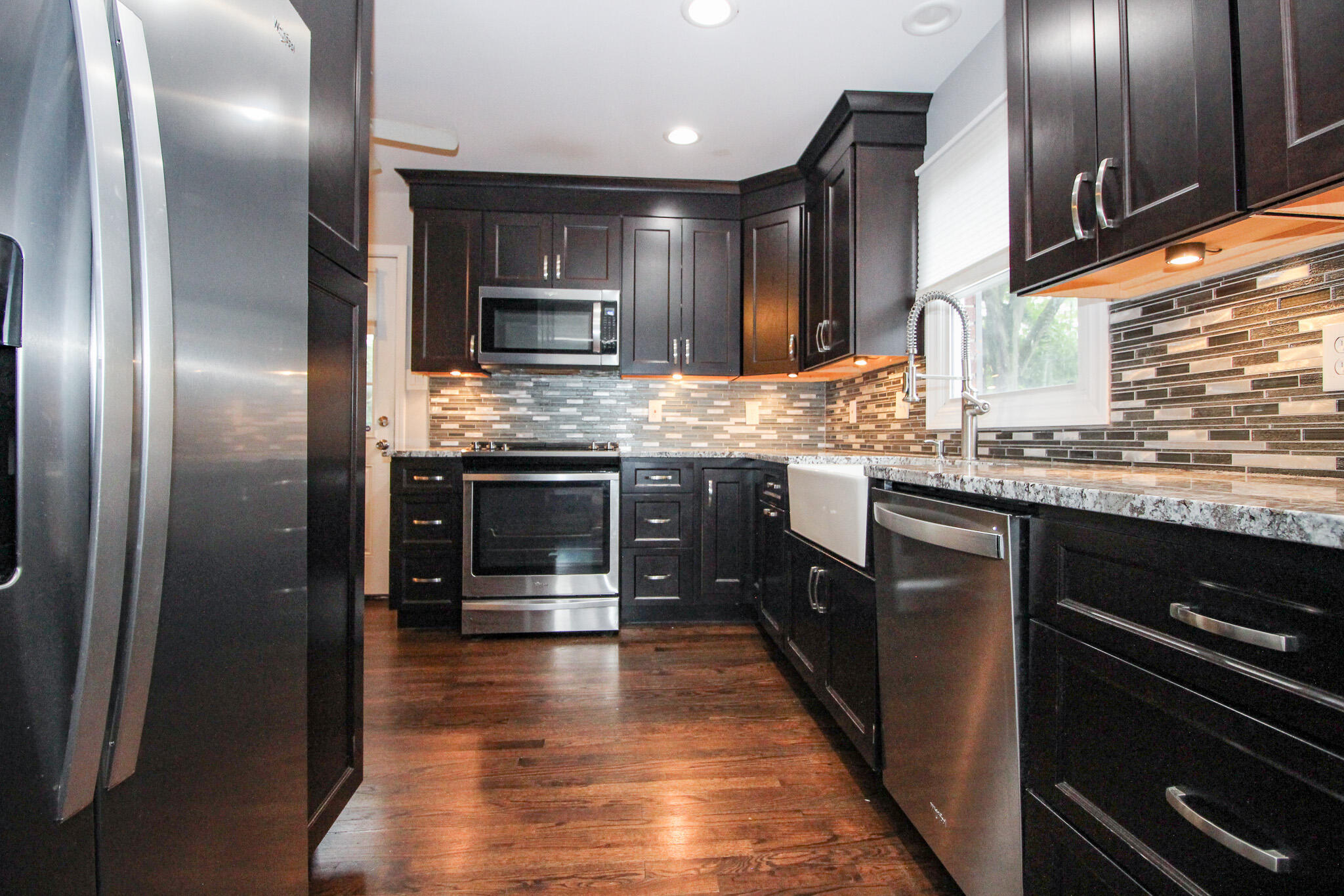 522 Dexter Drive Crown Point, IN 46307 - Photo 7 of 21 a kitchen with stainless steel appliances granite countertop a stove a sink and a refrigerator
