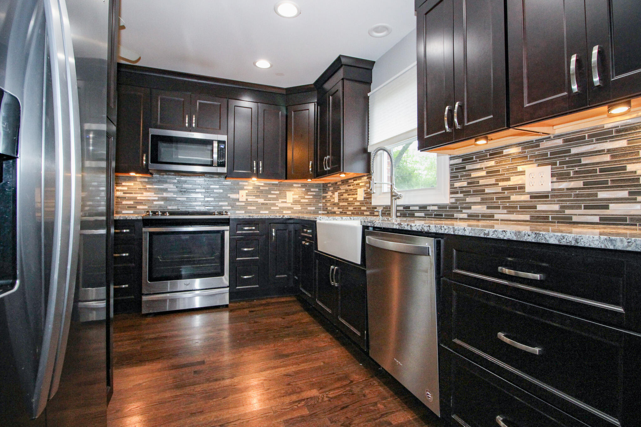522 Dexter Drive Crown Point, IN 46307 - Photo 8 of 21 a kitchen with stainless steel appliances kitchen island granite countertop a stove a sink and a microwave