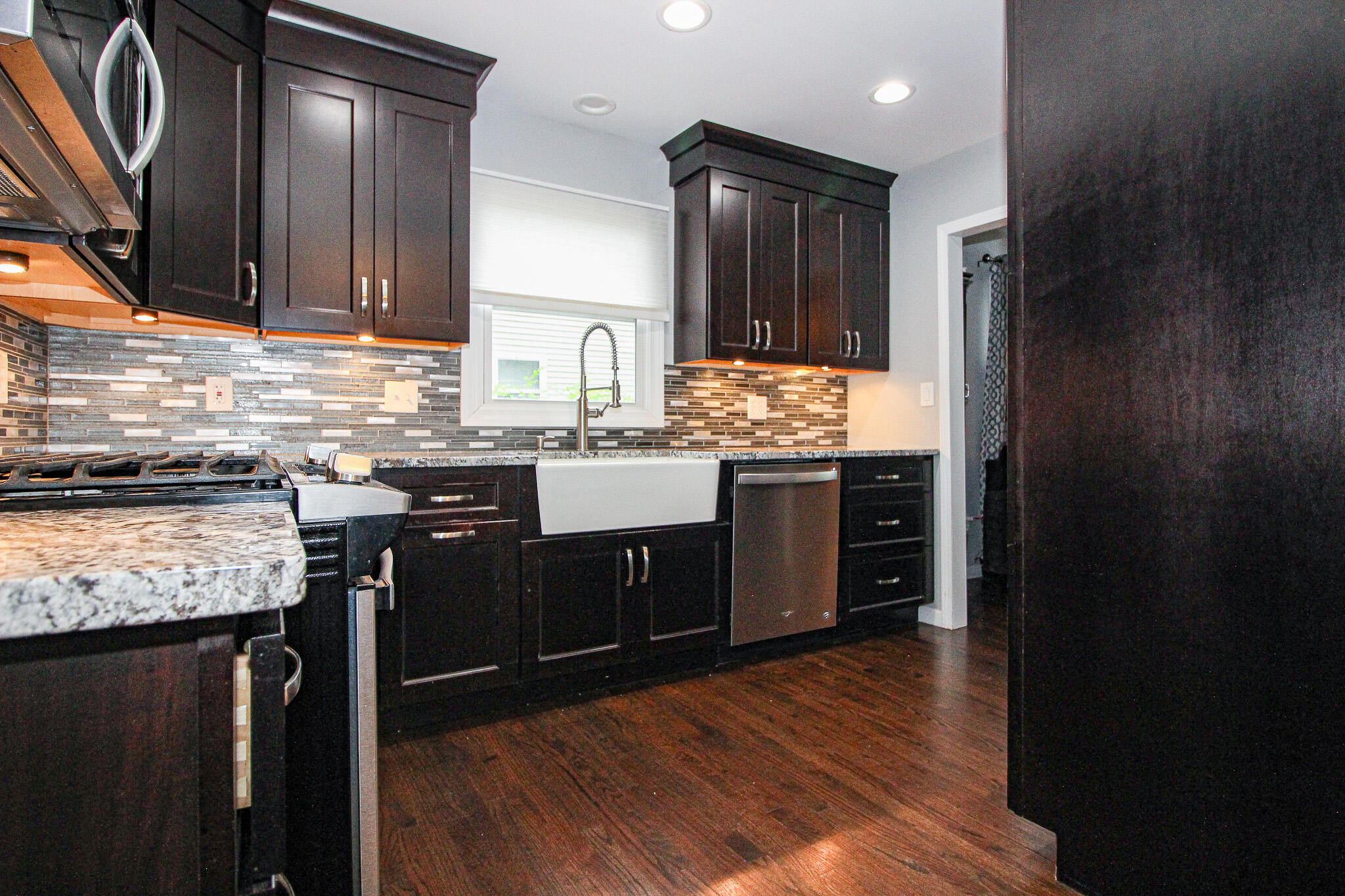 522 Dexter Drive Crown Point, IN 46307 - Photo 9 of 21 a kitchen with granite countertop a sink stove and cabinets