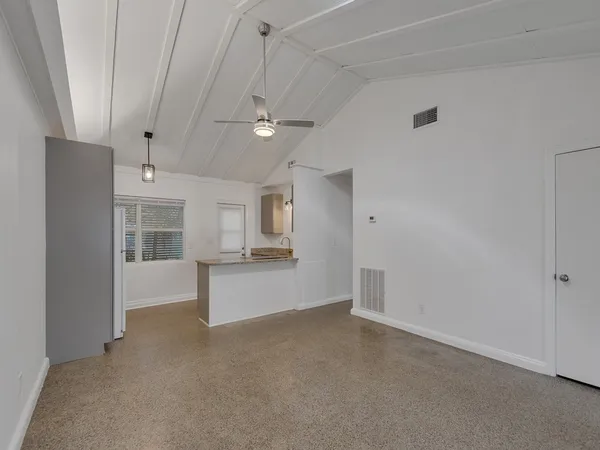 a view of a kitchen with a sink and a refrigerator