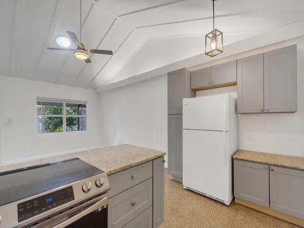 a kitchen with granite countertop a sink and chandelier