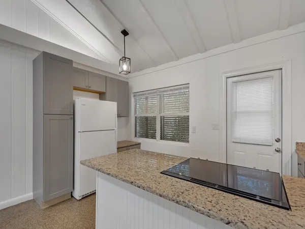 a kitchen with a sink dishwasher stove and cabinets