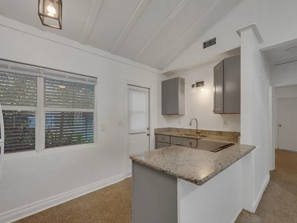 a view of a house with yard and balcony