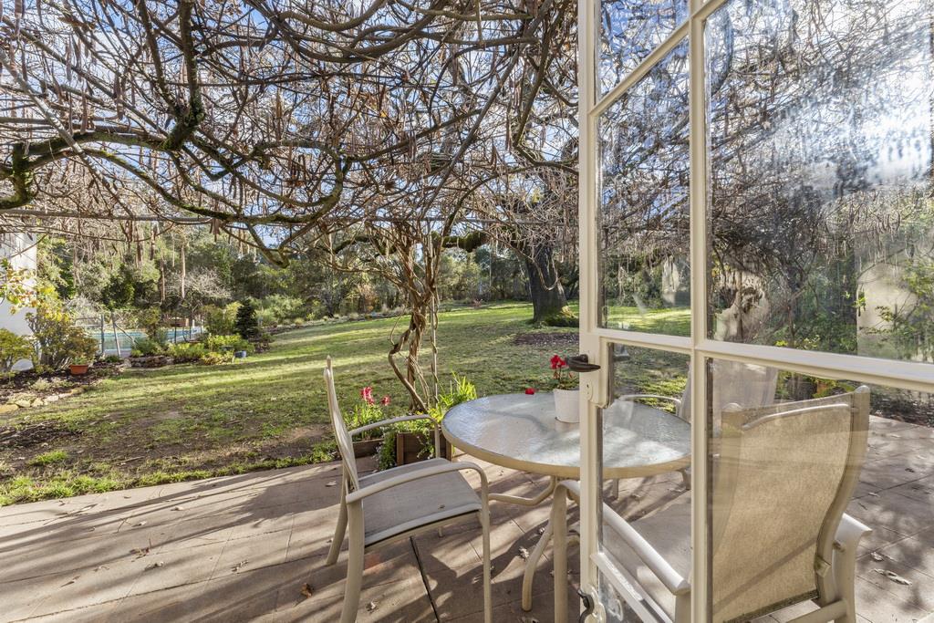 440 Gerona Road Stanford, CA 94305 - Photo 73 of 78 a view of a patio with table and chairs and wooden fence