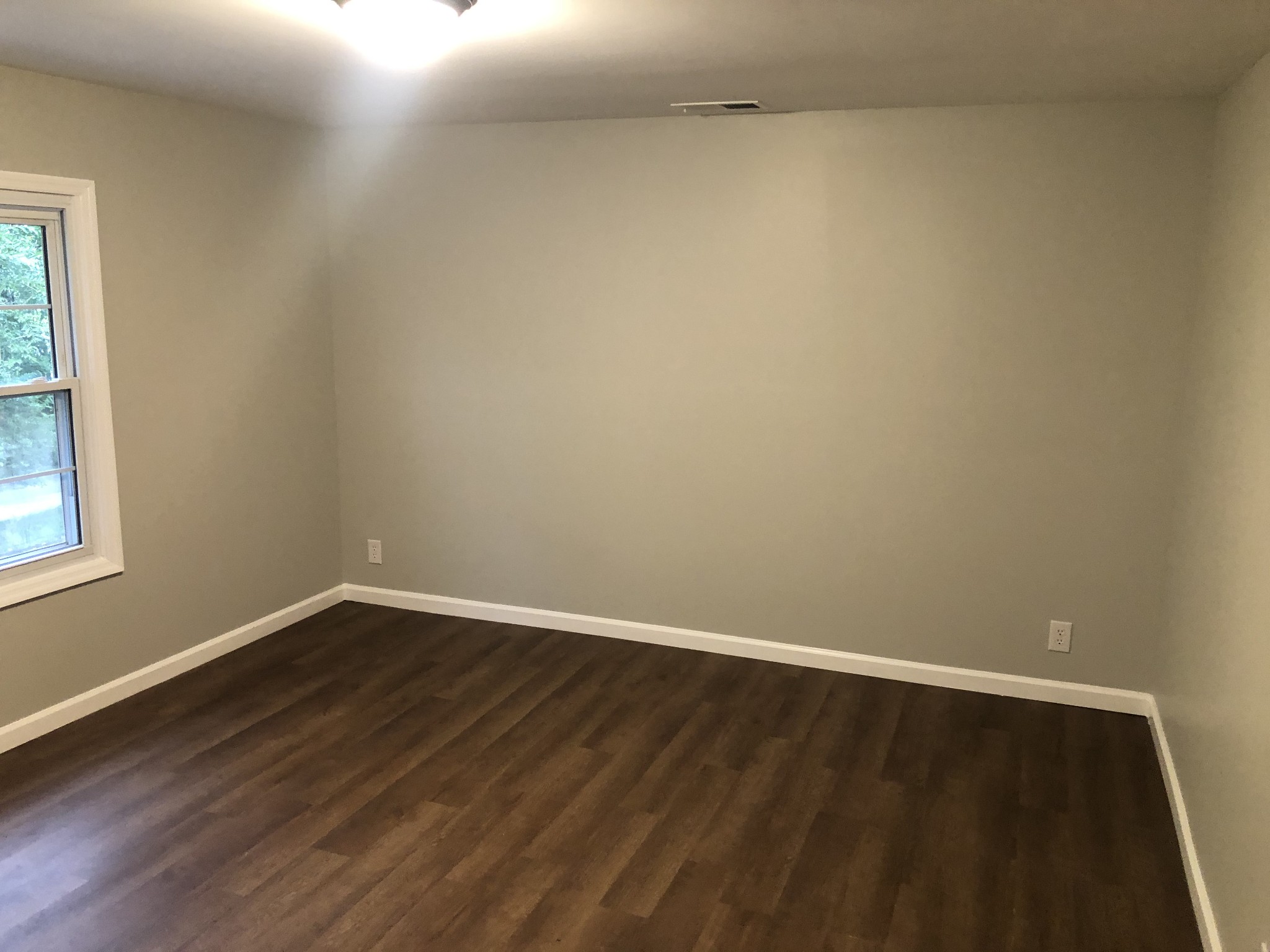 228 Peytons Creek Road Carthage, TN 37030 - Photo 11 of 18 a view of an empty room with wooden floor and a window