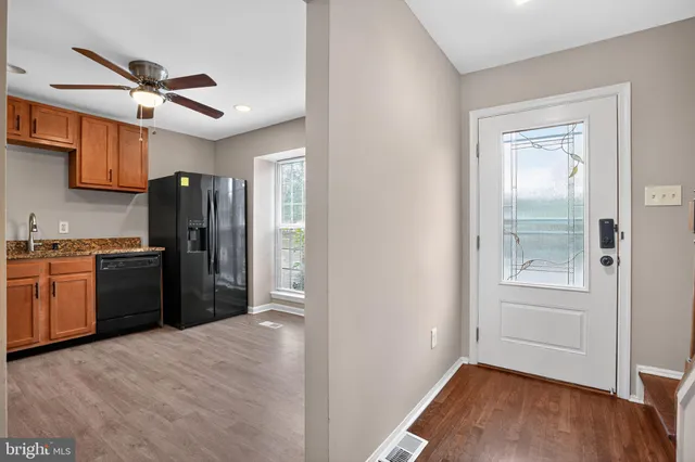 a kitchen with a refrigerator cabinet and a sink