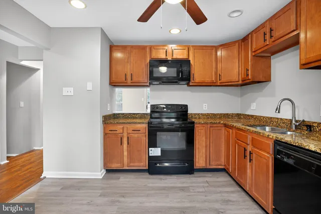 a kitchen with stainless steel appliances granite countertop a stove and a sink