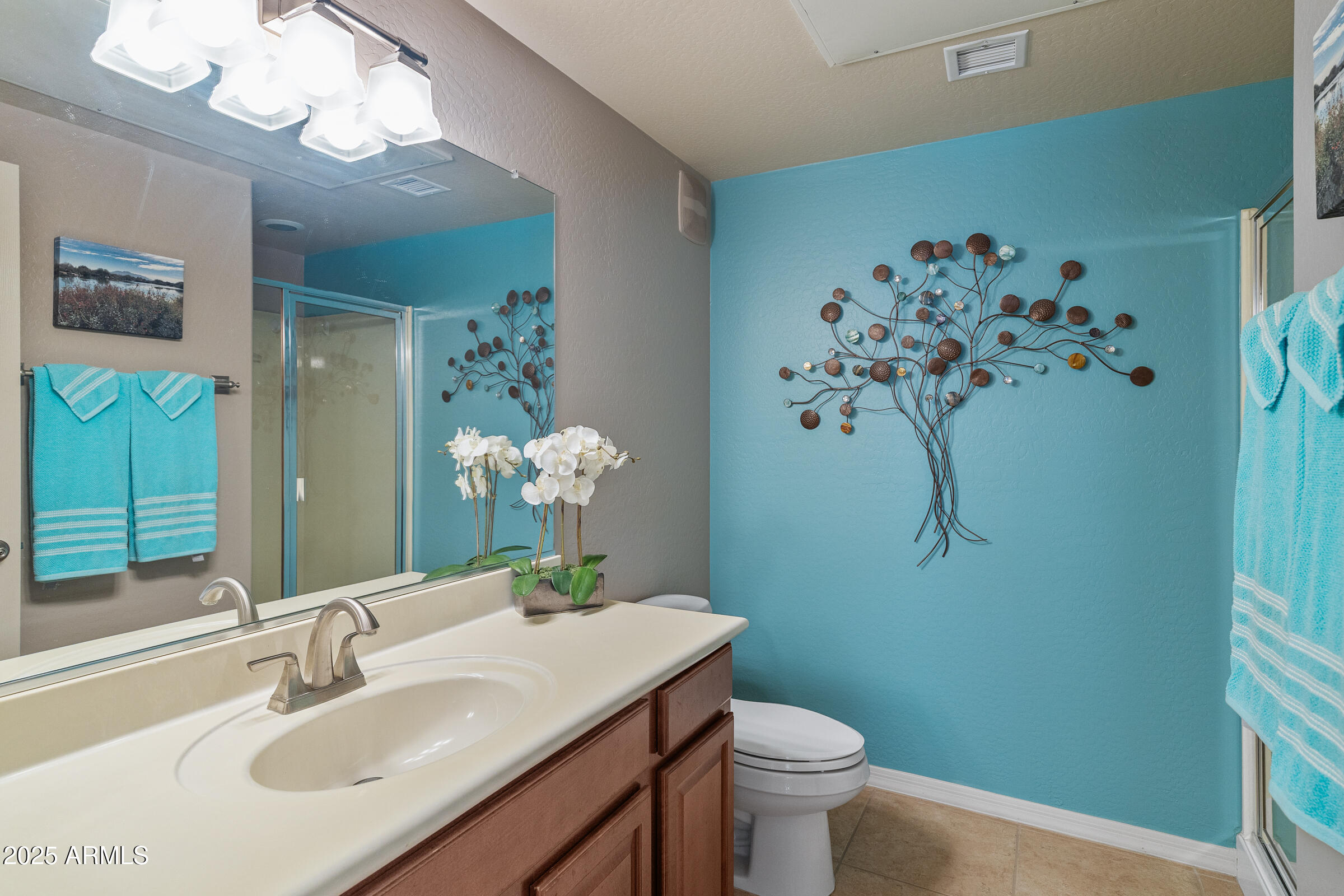 3330 South Gilbert Road, Unit 1013 Chandler, AZ 85286 - Photo 17 of 38 a bathroom with a sink vanity mirror and toilet