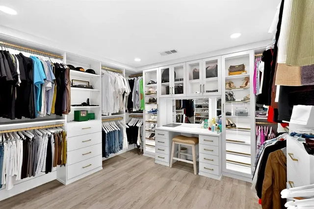 a view of a kitchen with cabinets and wooden floor