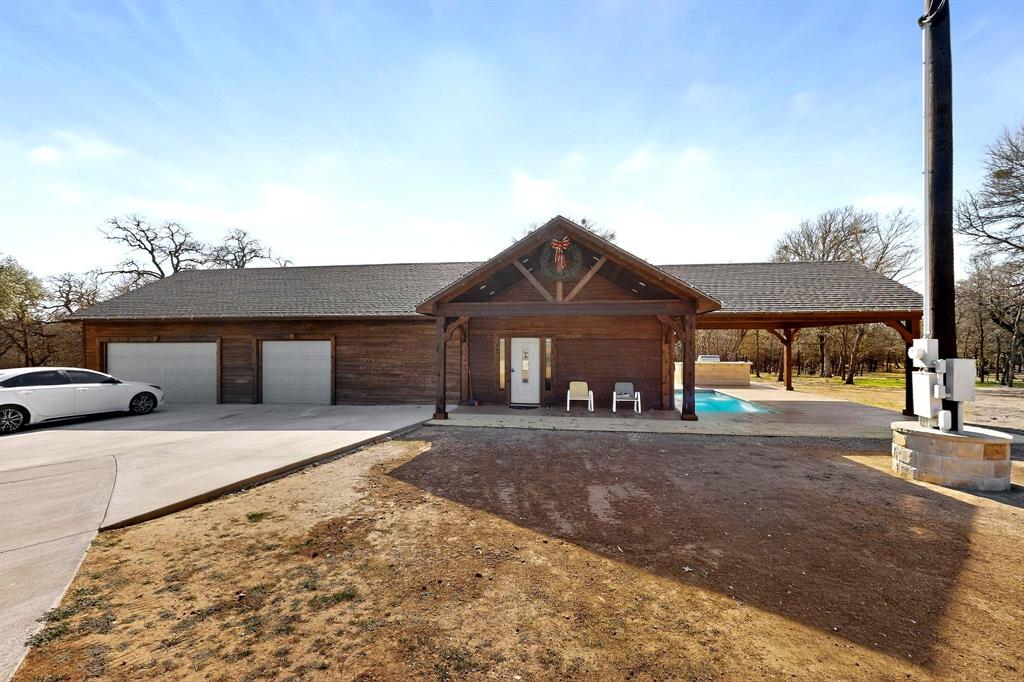 3095 Carter Road Springtown, TX 76082 - Photo 6 of 27 a front view of a house with a yard and garage