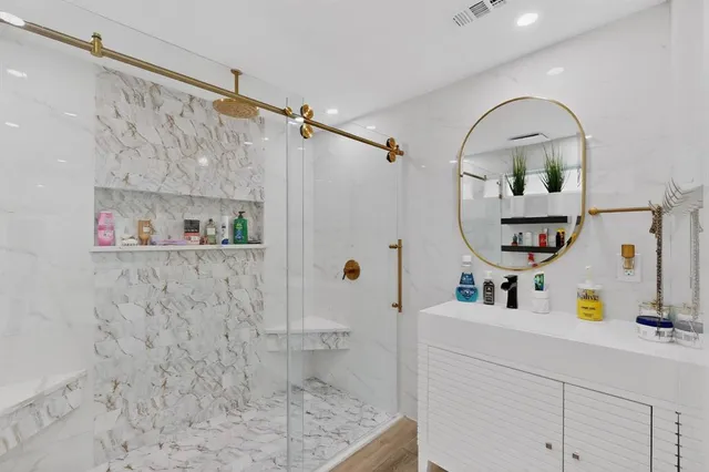 a bathroom with a sink mirror toilet and view of bathroom