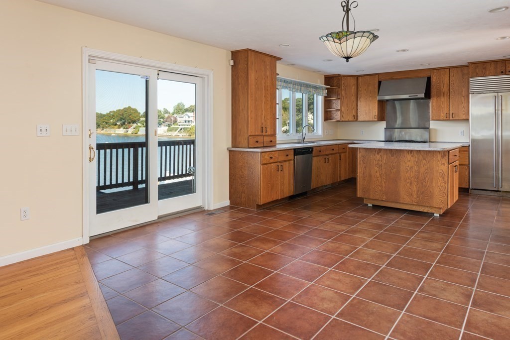 22 Cove Street Wareham, MA 02558 - Photo 15 of 35 a large kitchen with a large window and stainless steel appliances