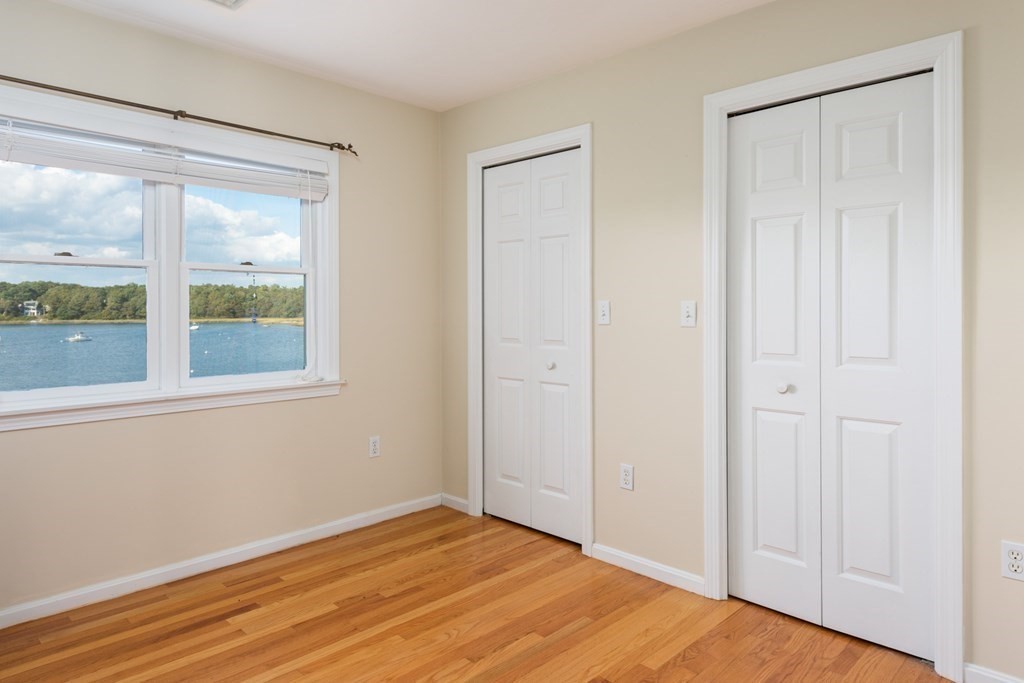 22 Cove Street Wareham, MA 02558 - Photo 22 of 35 a view of an empty room with wooden floor and a window