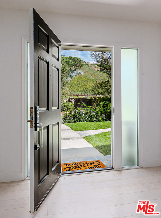 1075 Moraga Drive Los Angeles, CA 90049 - Photo 1 of 24 a view of an entryway with a floor to ceiling window
