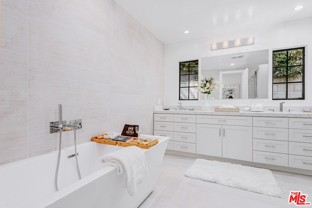 1075 Moraga Drive Los Angeles, CA 90049 - Photo 12 of 24 a bathroom with a sink and a mirror
