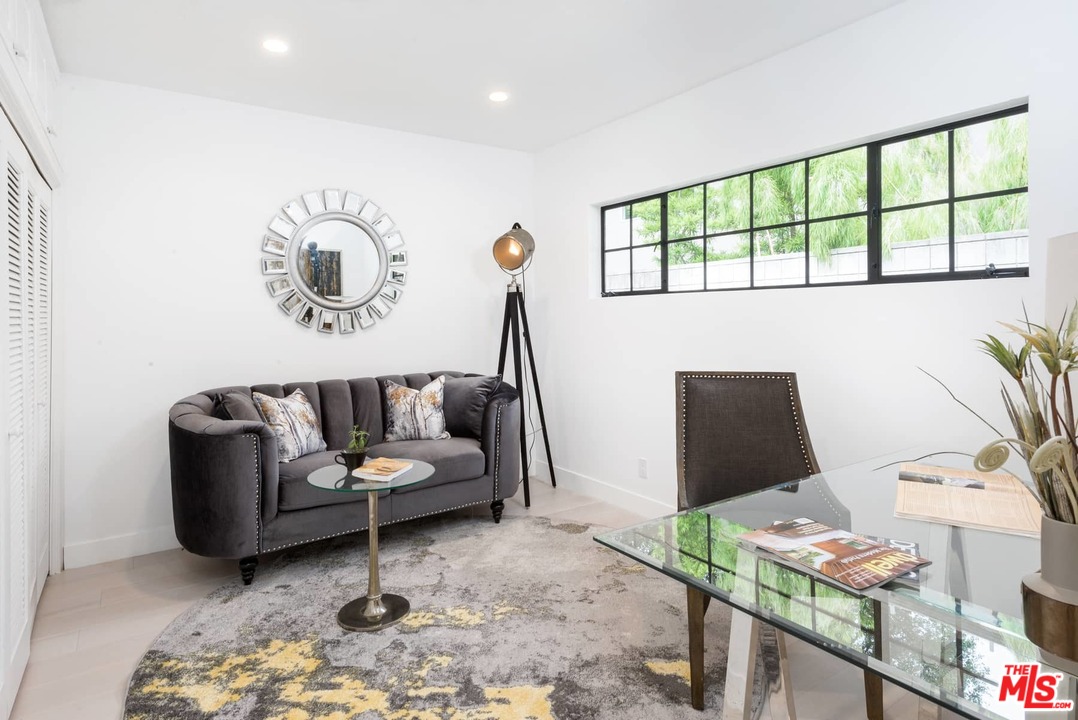 1075 Moraga Drive Los Angeles, CA 90049 - Photo 14 of 24 a living room with furniture and a flat screen tv