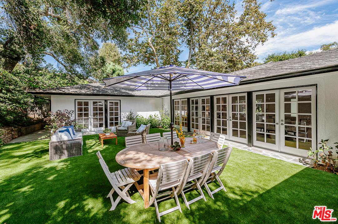 1075 Moraga Drive Los Angeles, CA 90049 - Photo 21 of 24 a view of a house with backyard and sitting area
