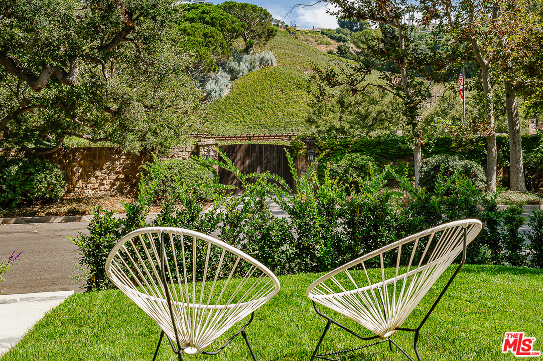 1075 Moraga Drive Los Angeles, CA 90049 - Photo 23 of 24 a balcony with trees in front of it