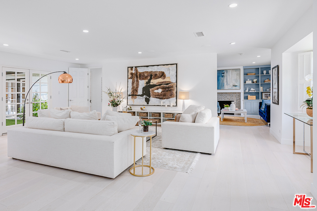 1075 Moraga Drive Los Angeles, CA 90049 - Photo 6 of 24 a living room with furniture and a large window