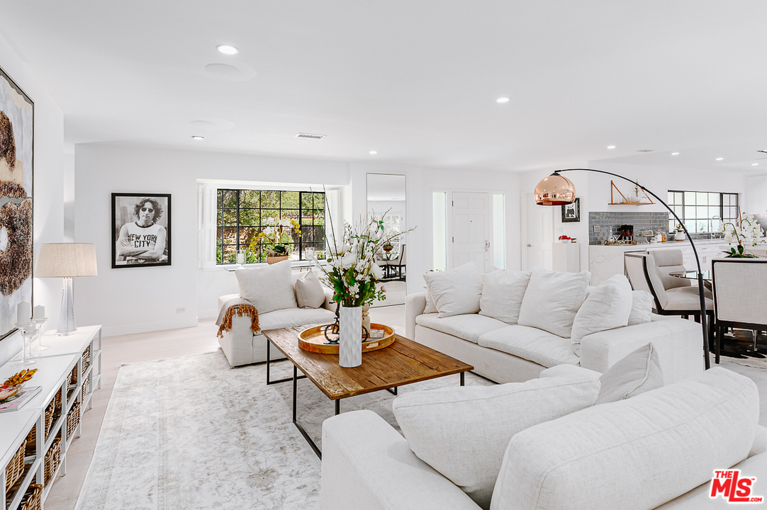 1075 Moraga Drive Los Angeles, CA 90049 - Photo 7 of 24 a living room with furniture and a flat screen tv