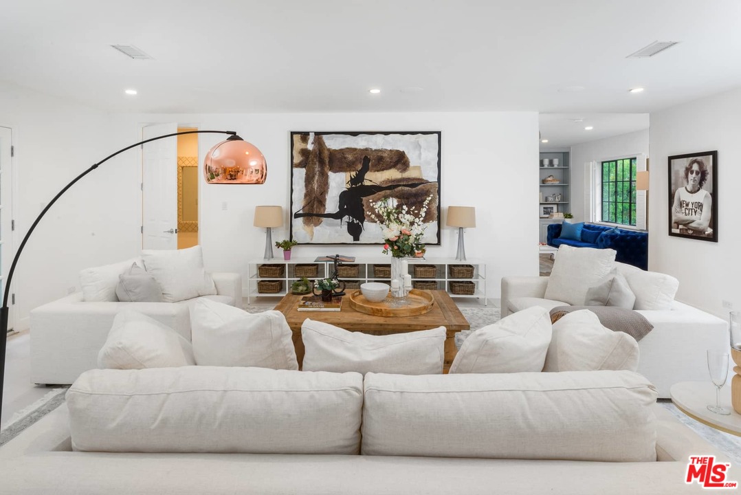 1075 Moraga Drive Los Angeles, CA 90049 - Photo 9 of 24 a living room with furniture and a potted plant