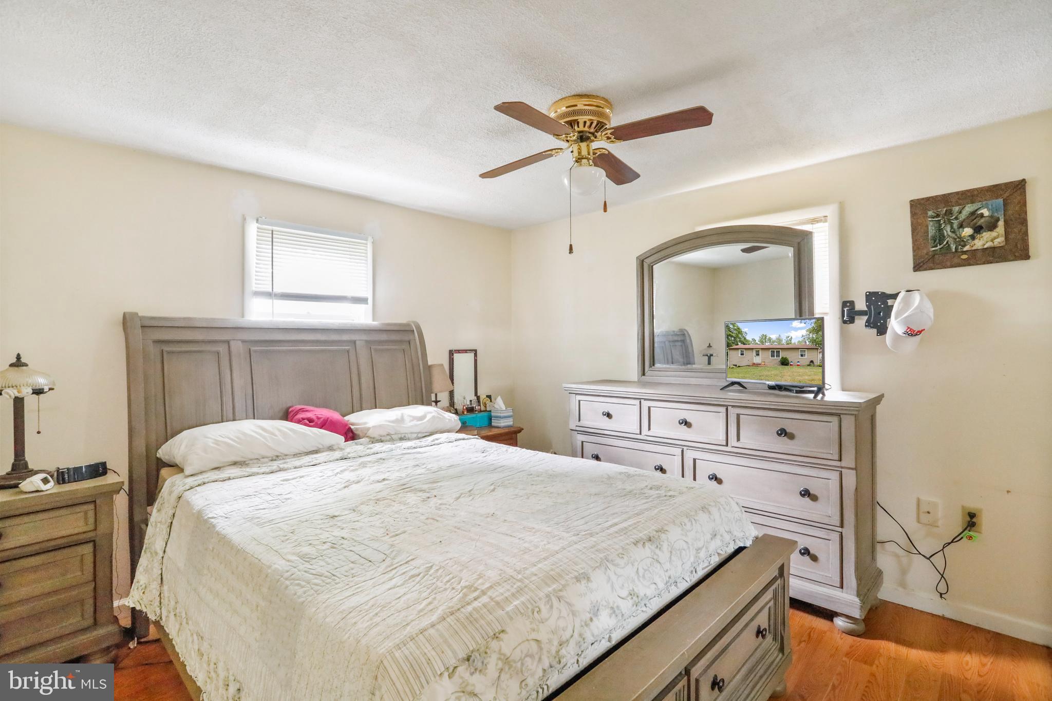 13618 Coppermine Road Union Bridge, MD 21791 - Photo 13 of 29 a bedroom with a bed a chandelier and dresser