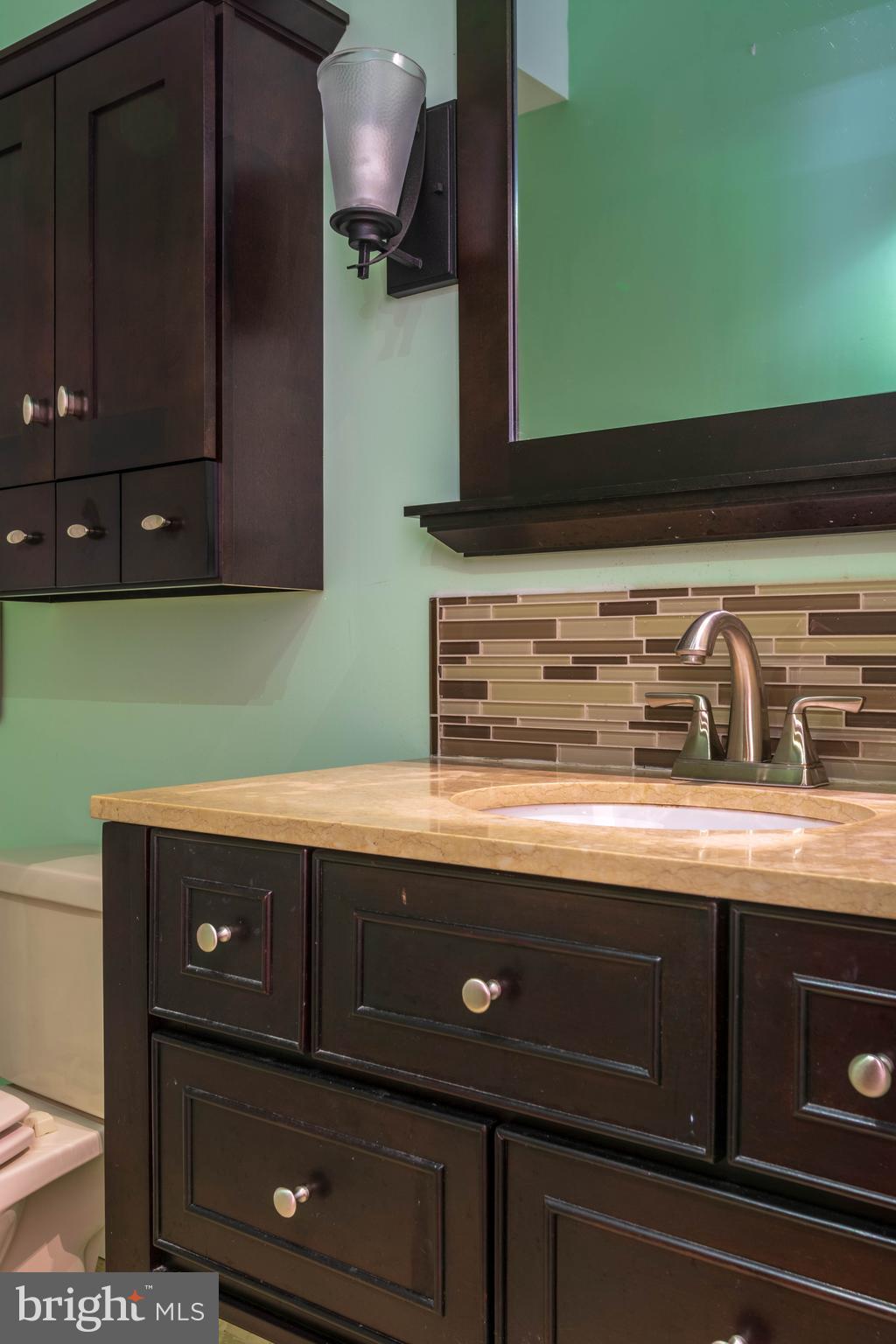 11227 Rawhide Road Lusby, MD 20657 - Photo 14 of 30 a view of a kitchen with a sink and cabinets