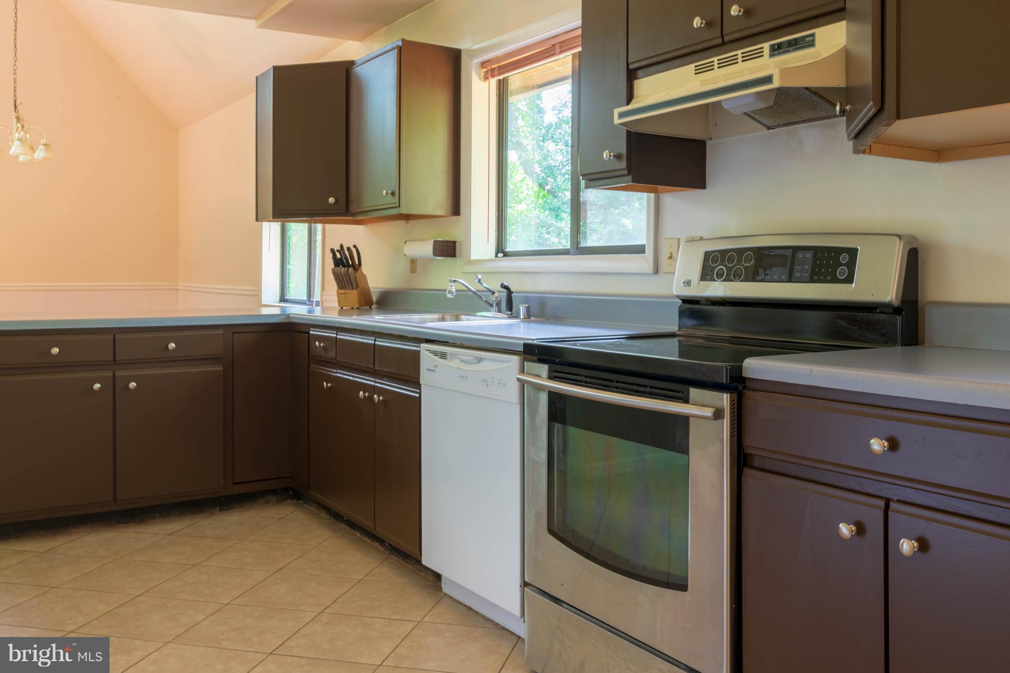 11227 Rawhide Road Lusby, MD 20657 - Photo 3 of 30 a kitchen with a sink stove and microwave