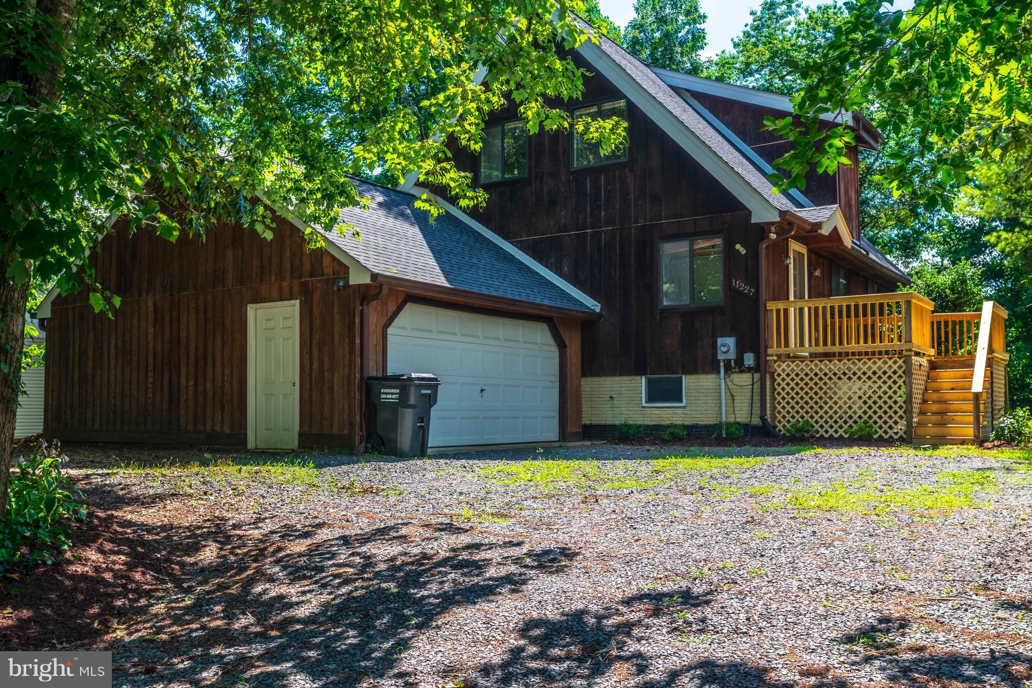 11227 Rawhide Road Lusby, MD 20657 - Photo 25 of 30 a view of a house with a yard and a large tree