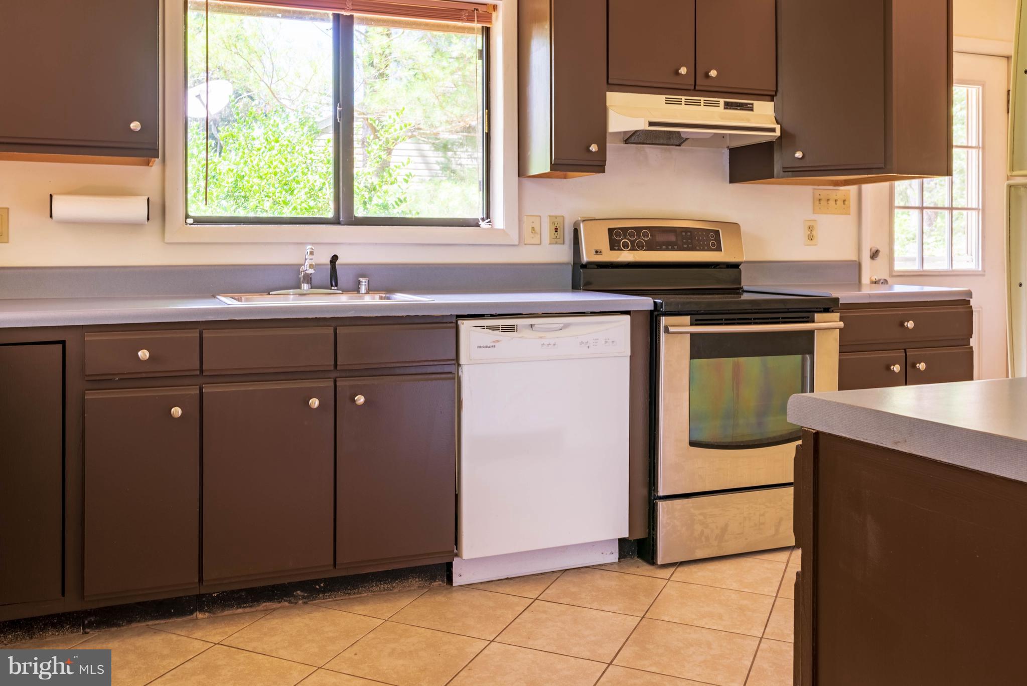 11227 Rawhide Road Lusby, MD 20657 - Photo 4 of 30 a kitchen with stainless steel appliances granite countertop a sink stove and refrigerator