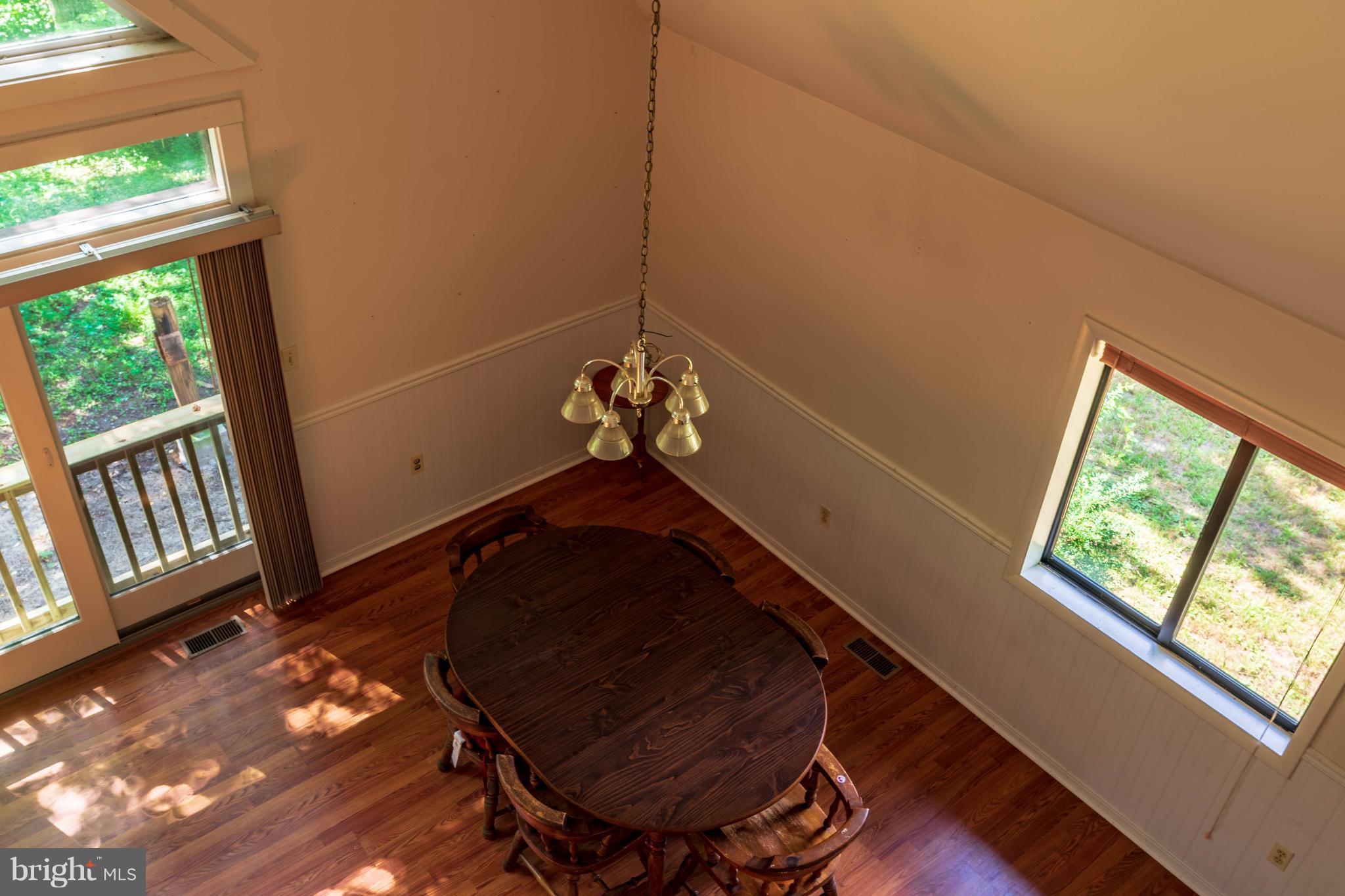 11227 Rawhide Road Lusby, MD 20657 - Photo 9 of 30 a room with wooden floor and windows